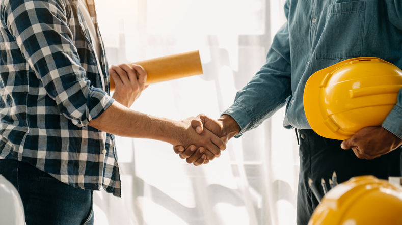 a contractor shakes hands with a customer