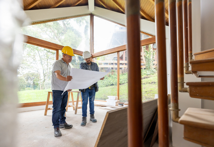 contractors review blueprints for a home